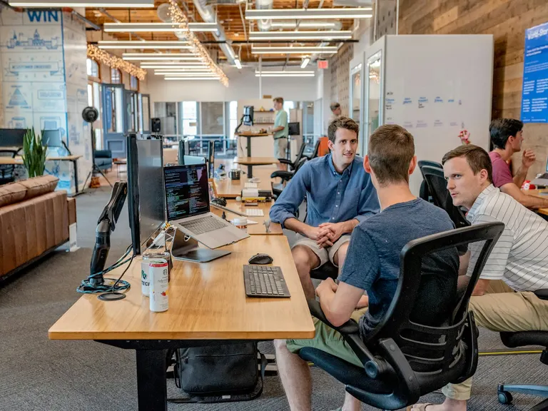 Professionals collaborating in an office, illustrative photograph